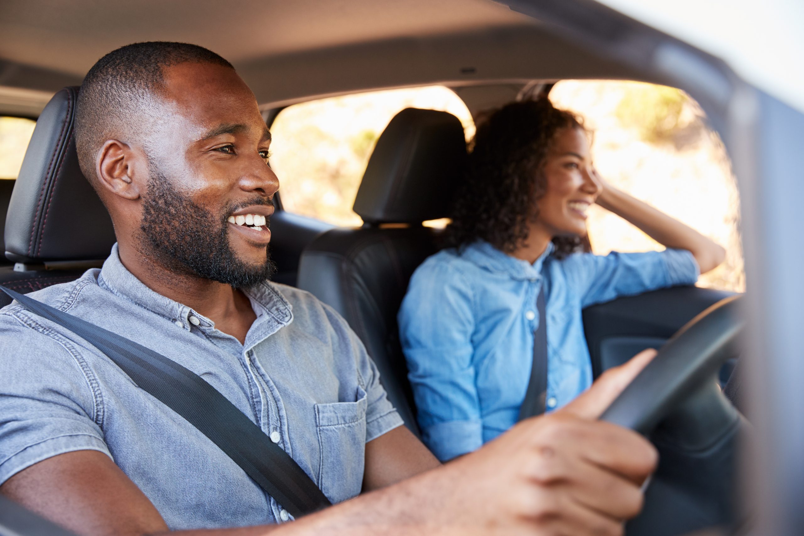 Young,Black,Couple,In,Car,On,A,Road,Trip,Look